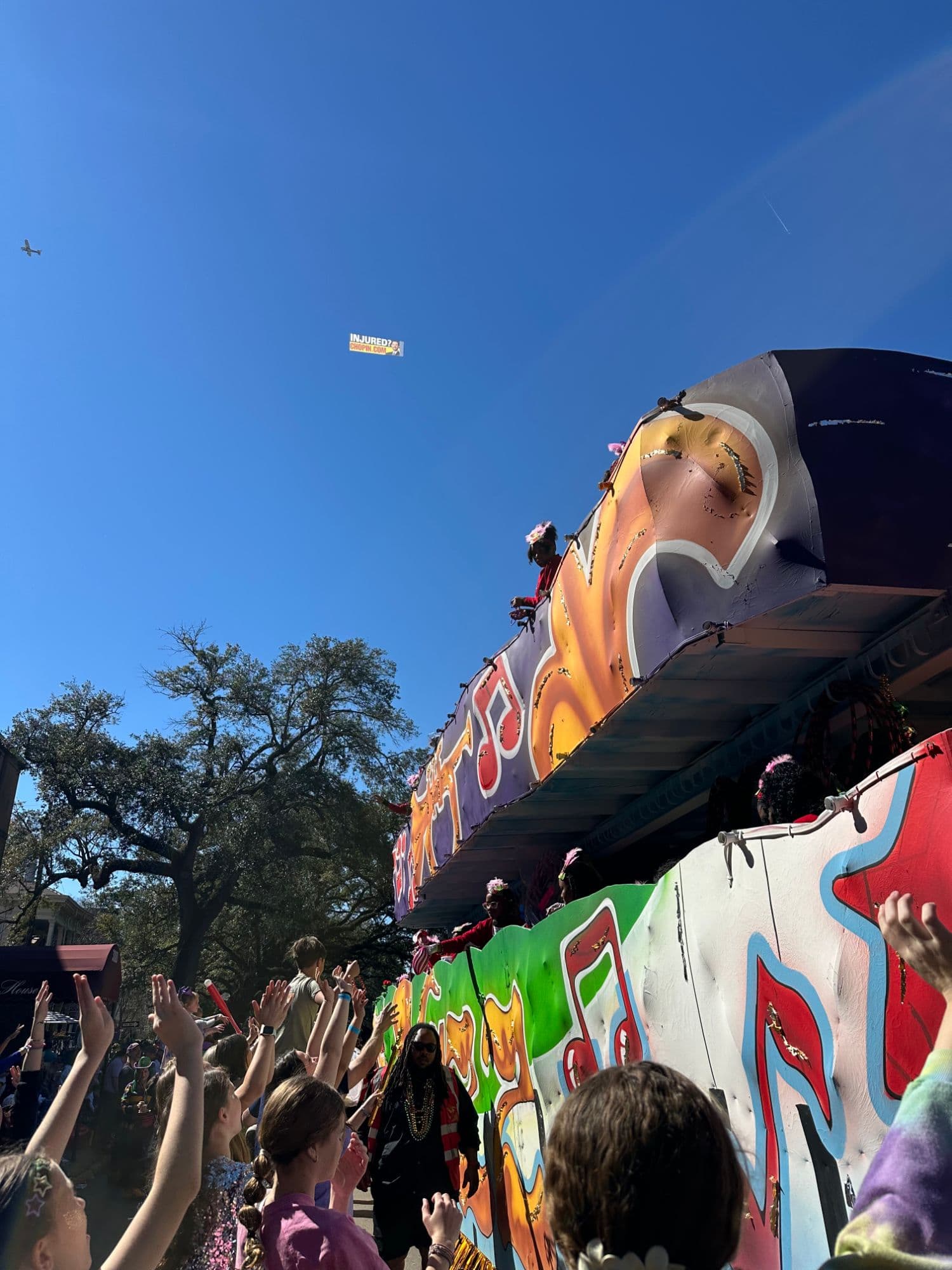 Pelican Sky banner flying over a New Orleans parade route for the Chopin Law Firm